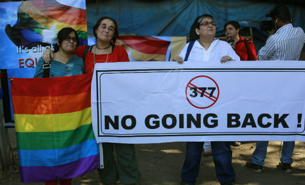 A group of activists hold a banner against section 377 of the Indian Penal Code that criminalizes homosexuality during a protest in Mumbai on Wednesday - AP A group of activists hold a banner against section 377 of the Indian Penal Code that criminalizes homosexuality during a protest in Mumbai on Wednesday - AP